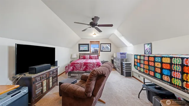a bedroom with furniture and a flat screen tv