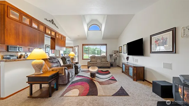 a living room with furniture fireplace and flat screen tv
