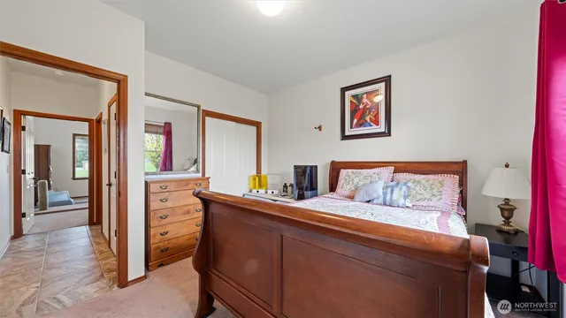 a bedroom with a bed and a dresser