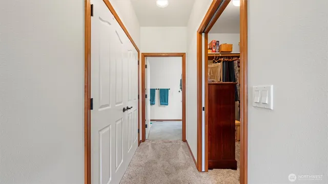 a view of a hallway with wooden floor and entryway