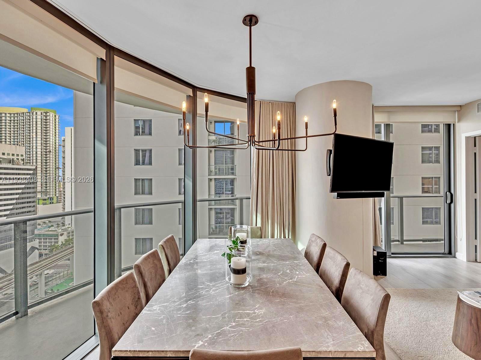 55 Southwest 9th Street, Unit 1808 Miami, FL 33130 - Photo 2 of 33 a living room with furniture and a flat screen tv