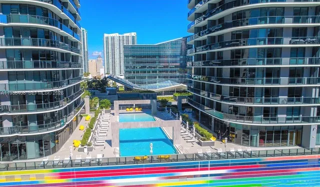 a view of a patio with swimming pool and outdoor seating