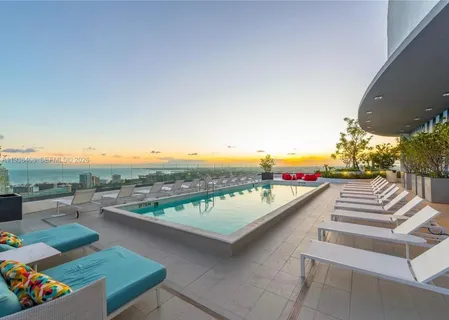 a view of swimming pool with outdoor seating