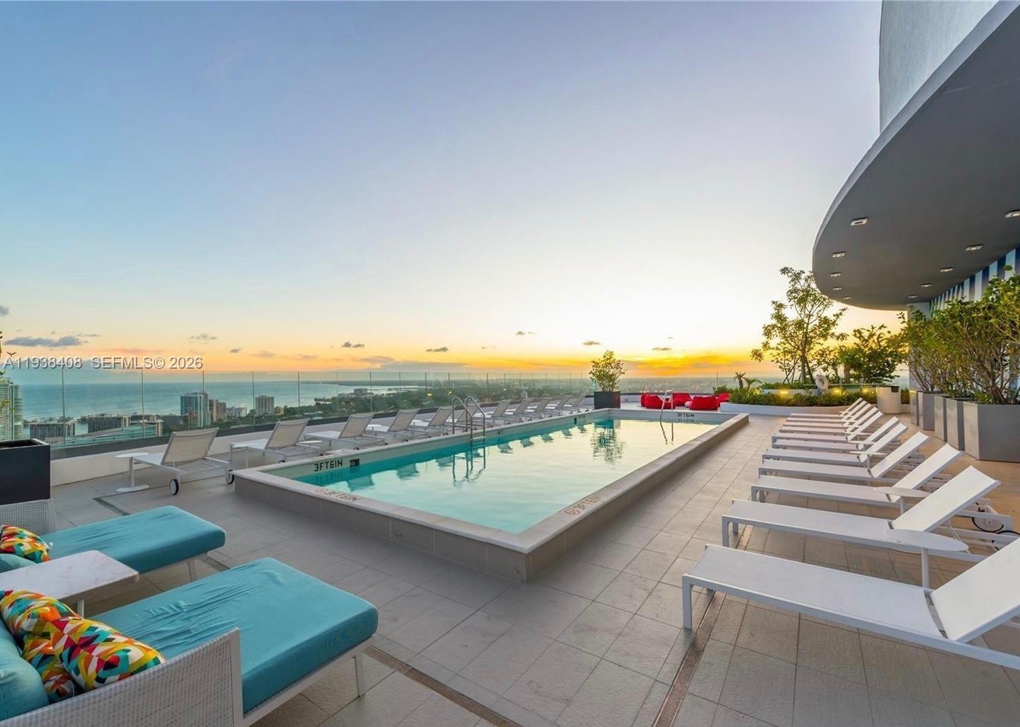 55 Southwest 9th Street, Unit 1808 Miami, FL 33130 - Photo 29 of 33 a view of a patio with swimming pool and outdoor seating