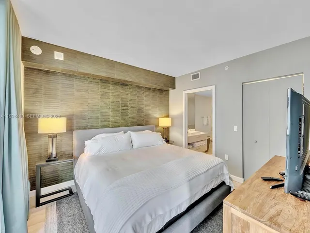 a bedroom with a bed and a lamp