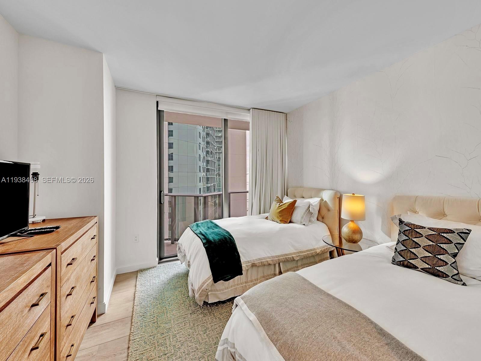 55 Southwest 9th Street, Unit 1808 Miami, FL 33130 - Photo 8 of 33 a bedroom with two beds and a window