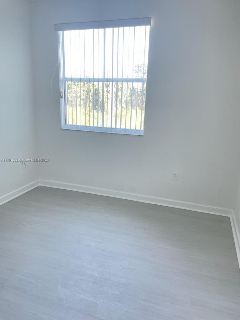 2903 Southeast 17th Avenue, Unit 206 Homestead, FL 33035 - Photo 17 of 28 an empty room with a window