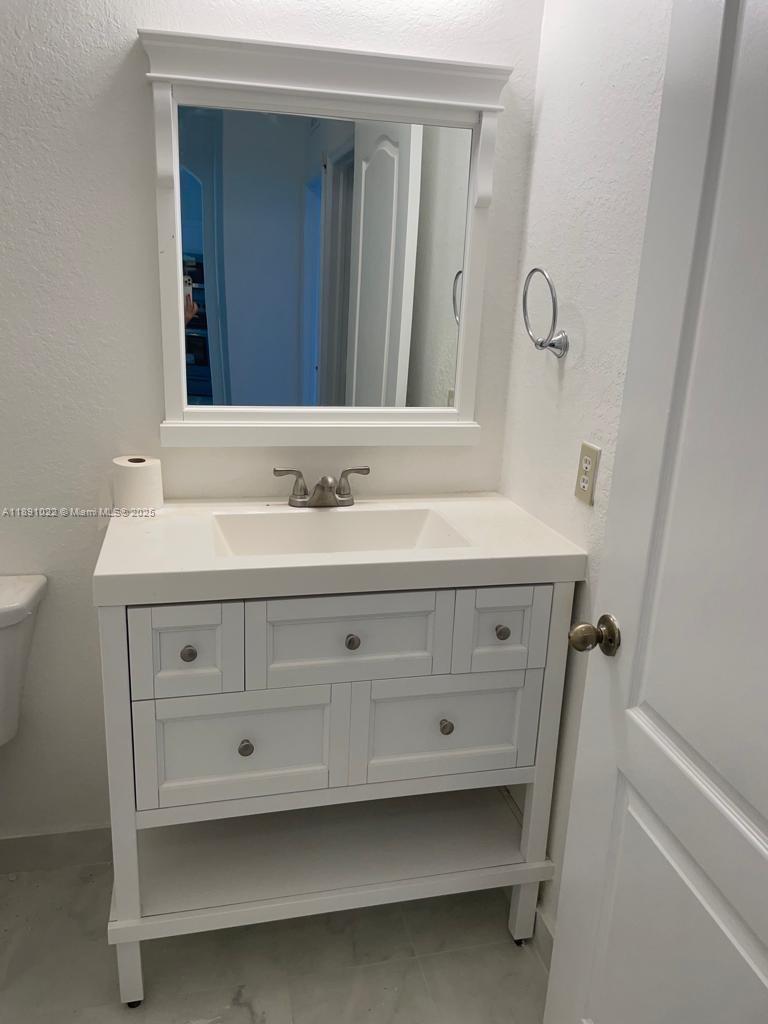 2903 Southeast 17th Avenue, Unit 206 Homestead, FL 33035 - Photo 18 of 28 a bathroom with a sink a vanity and a mirror