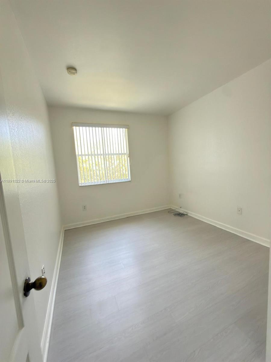 2903 Southeast 17th Avenue, Unit 206 Homestead, FL 33035 - Photo 20 of 28 an empty room with a window