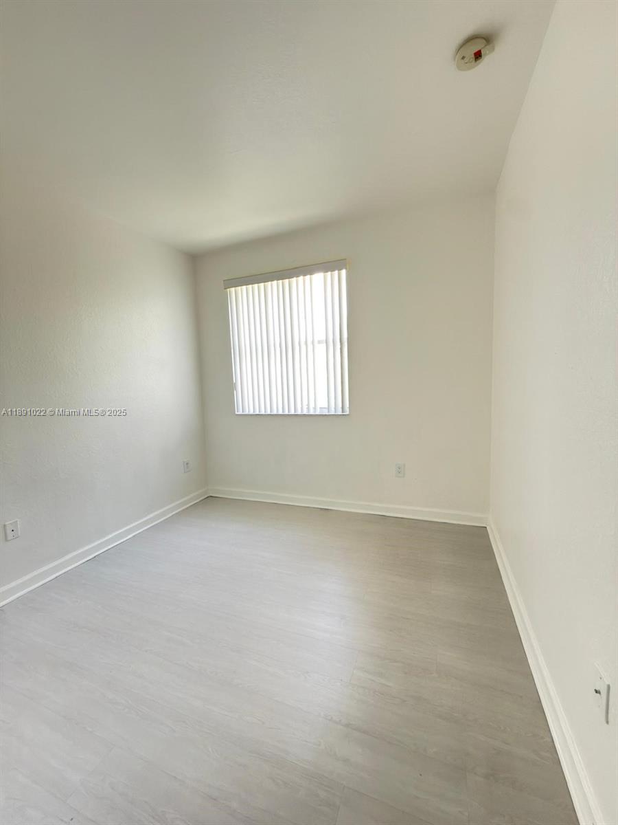 2903 Southeast 17th Avenue, Unit 206 Homestead, FL 33035 - Photo 22 of 28 an empty room with a window