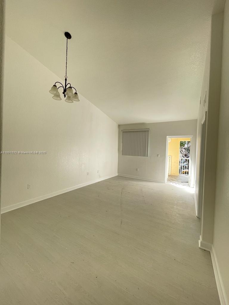 2903 Southeast 17th Avenue, Unit 206 Homestead, FL 33035 - Photo 3 of 28 a view of empty room with windows