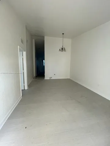 a kitchen with stainless steel appliances a stove a sink and white cabinets