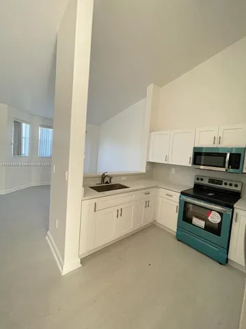 a stove top oven sitting inside of a kitchen