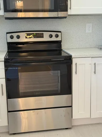 a kitchen with a refrigerator and cabinets