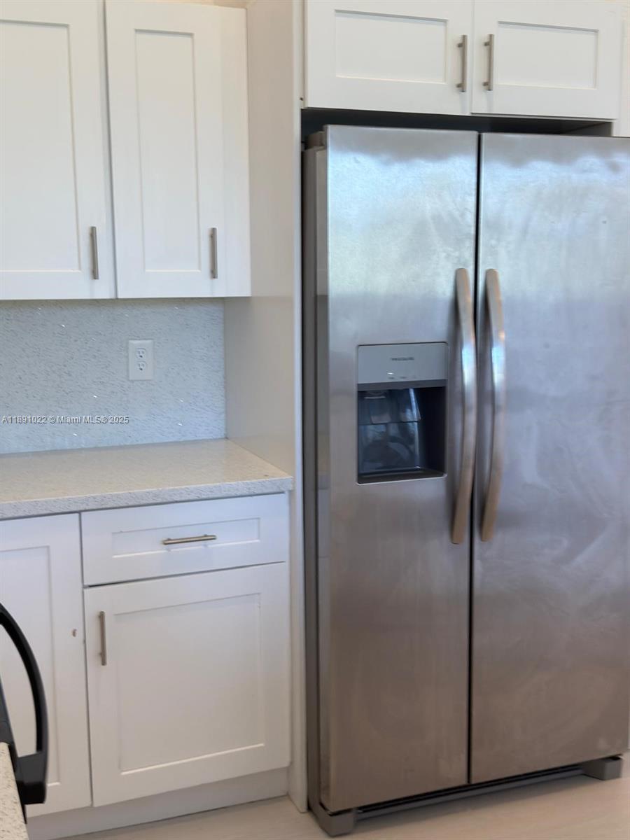 2903 Southeast 17th Avenue, Unit 206 Homestead, FL 33035 - Photo 7 of 28 a kitchen with a refrigerator and cabinets