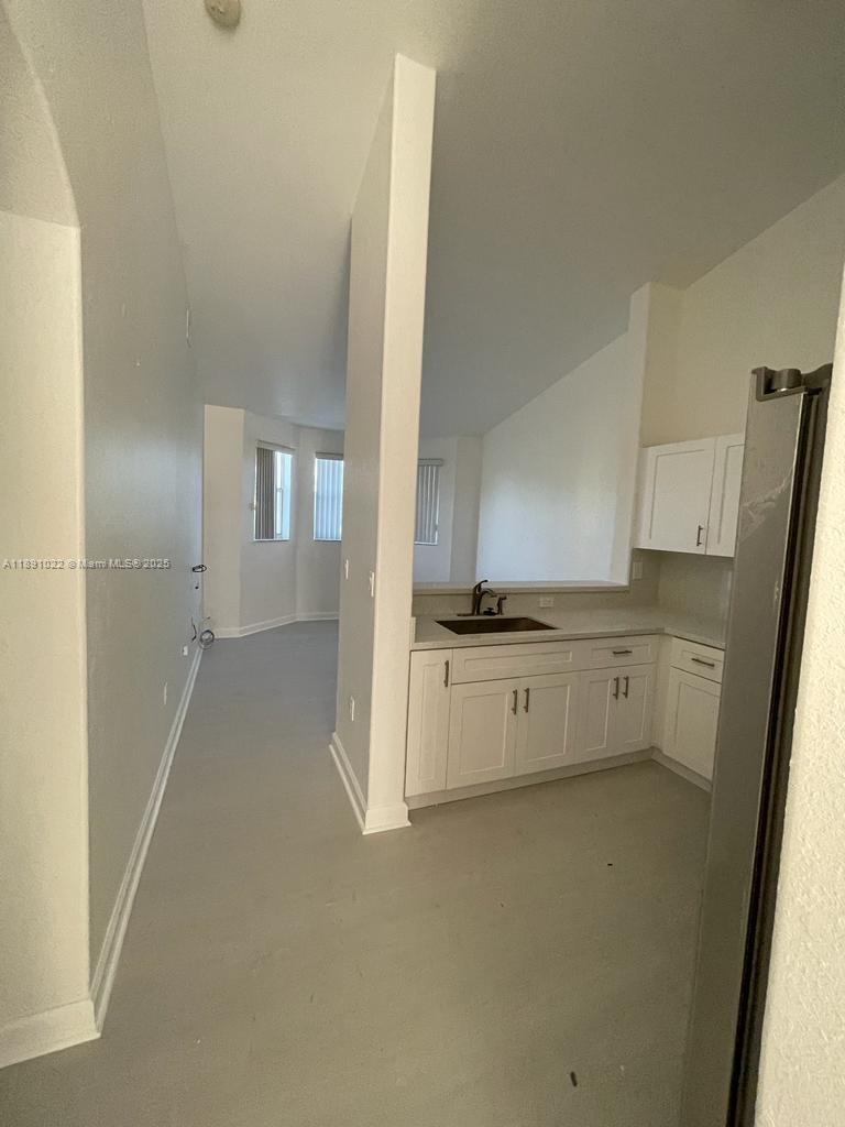 2903 Southeast 17th Avenue, Unit 206 Homestead, FL 33035 - Photo 8 of 28 a view of a kitchen with white cabinets