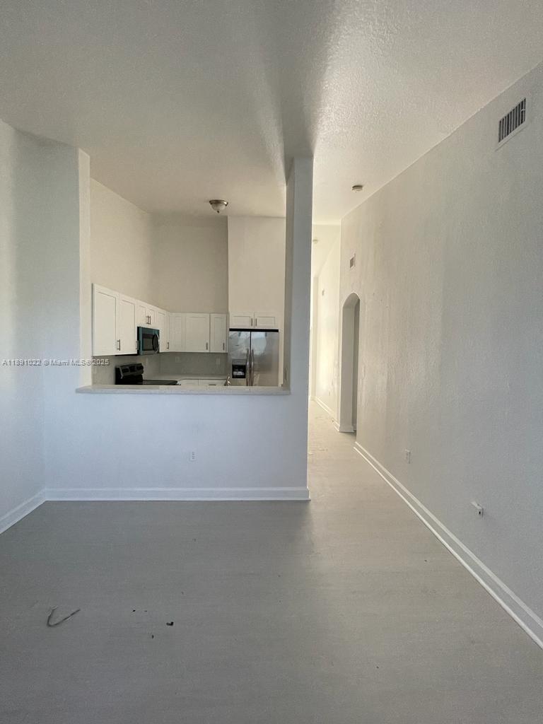 2903 Southeast 17th Avenue, Unit 206 Homestead, FL 33035 - Photo 9 of 28 a view of a kitchen with a sink and a refrigerator