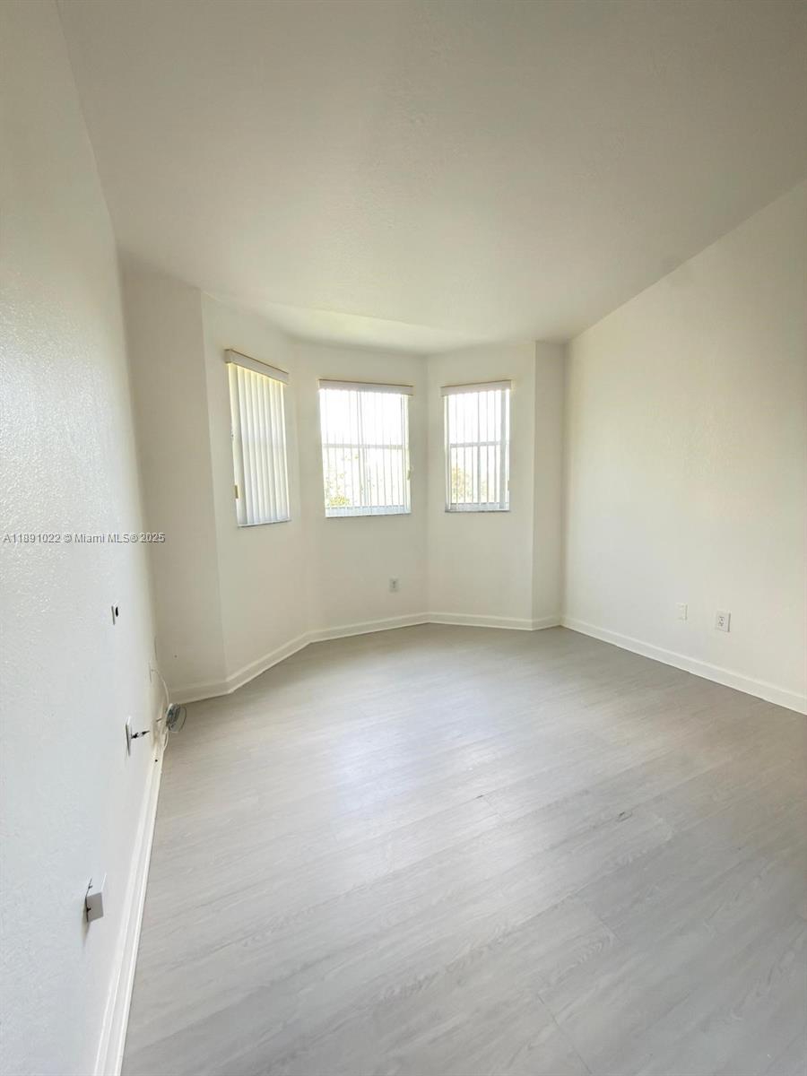 2903 Southeast 17th Avenue, Unit 206 Homestead, FL 33035 - Photo 10 of 28 an empty room with windows