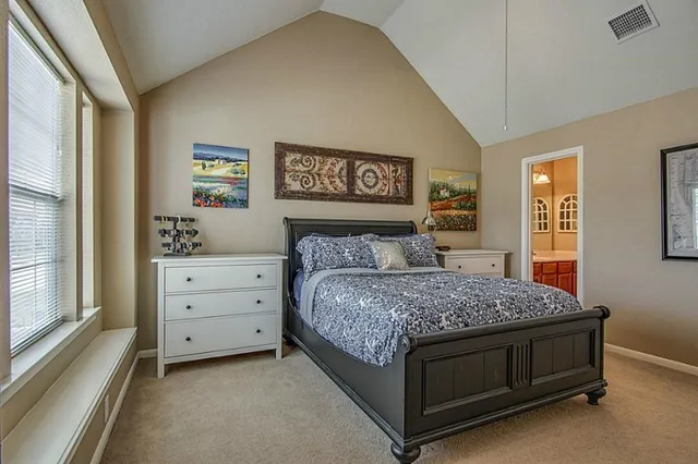 a bedroom with a bed and window