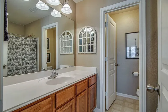 a bathroom with a sink a vanity and a mirror
