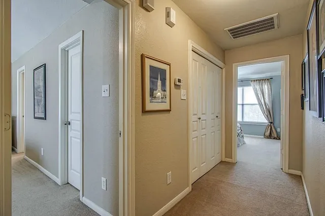 a view of a house with a backyard and a chair