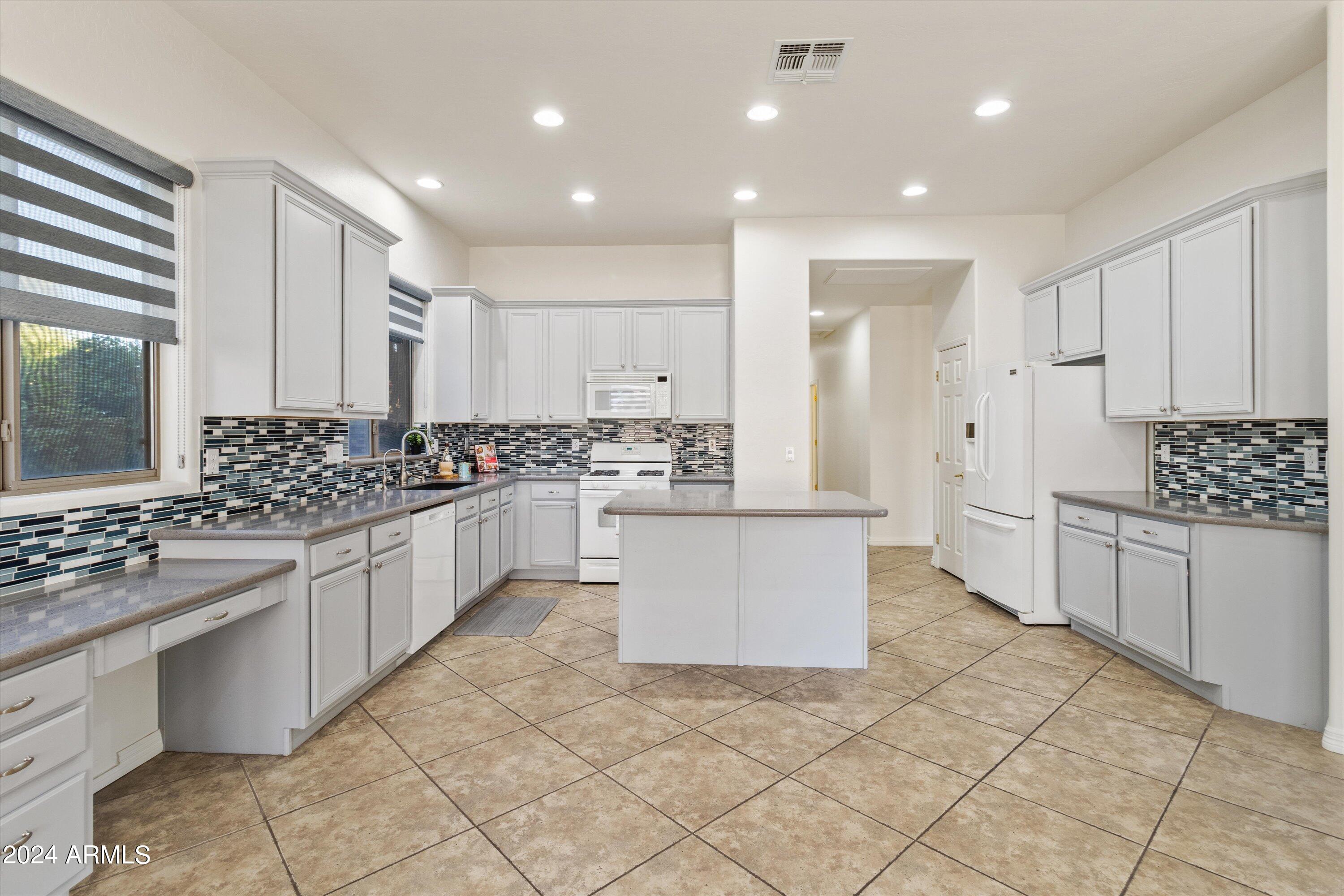 2860 East Nunneley Road Gilbert, AZ 85296 - Photo 12 of 28 a large white kitchen with cabinets