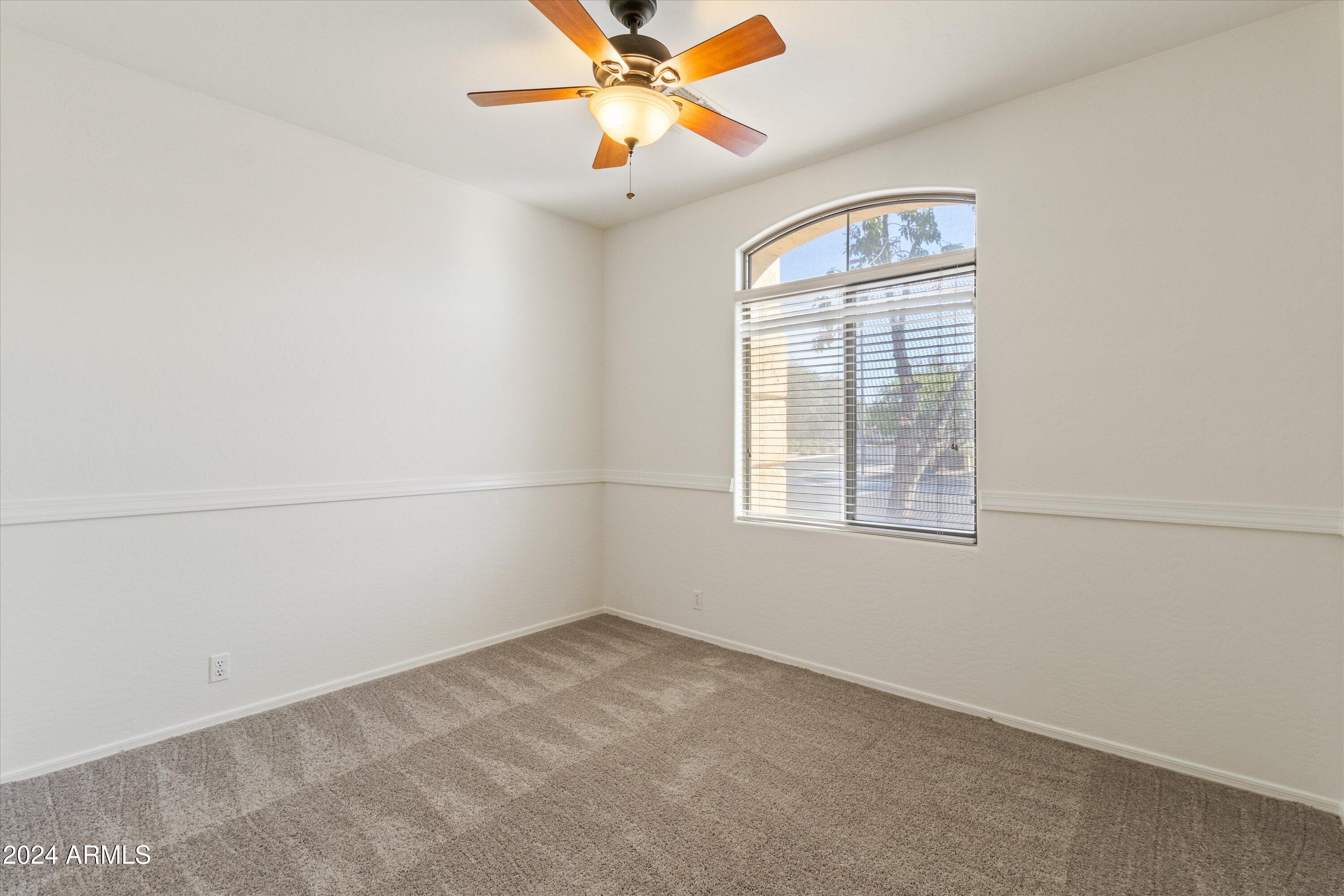 2860 East Nunneley Road Gilbert, AZ 85296 - Photo 17 of 28 an empty room with a window and a fan