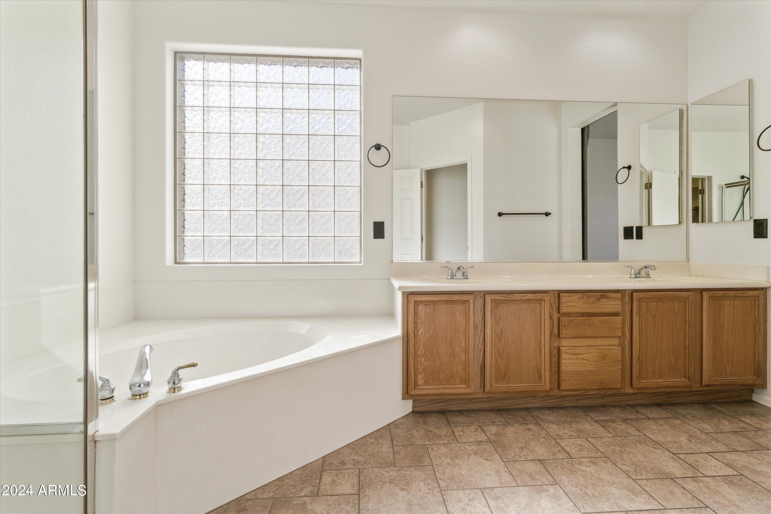 2860 East Nunneley Road Gilbert, AZ 85296 - Photo 20 of 28 a bathroom with a granite countertop tub sink and mirror