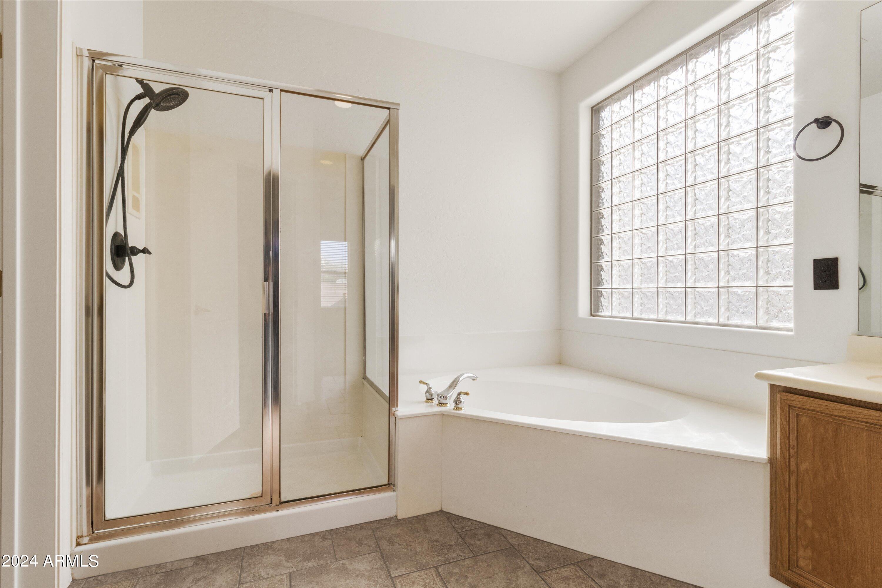 2860 East Nunneley Road Gilbert, AZ 85296 - Photo 21 of 28 a bathroom with a bathtub and a shower