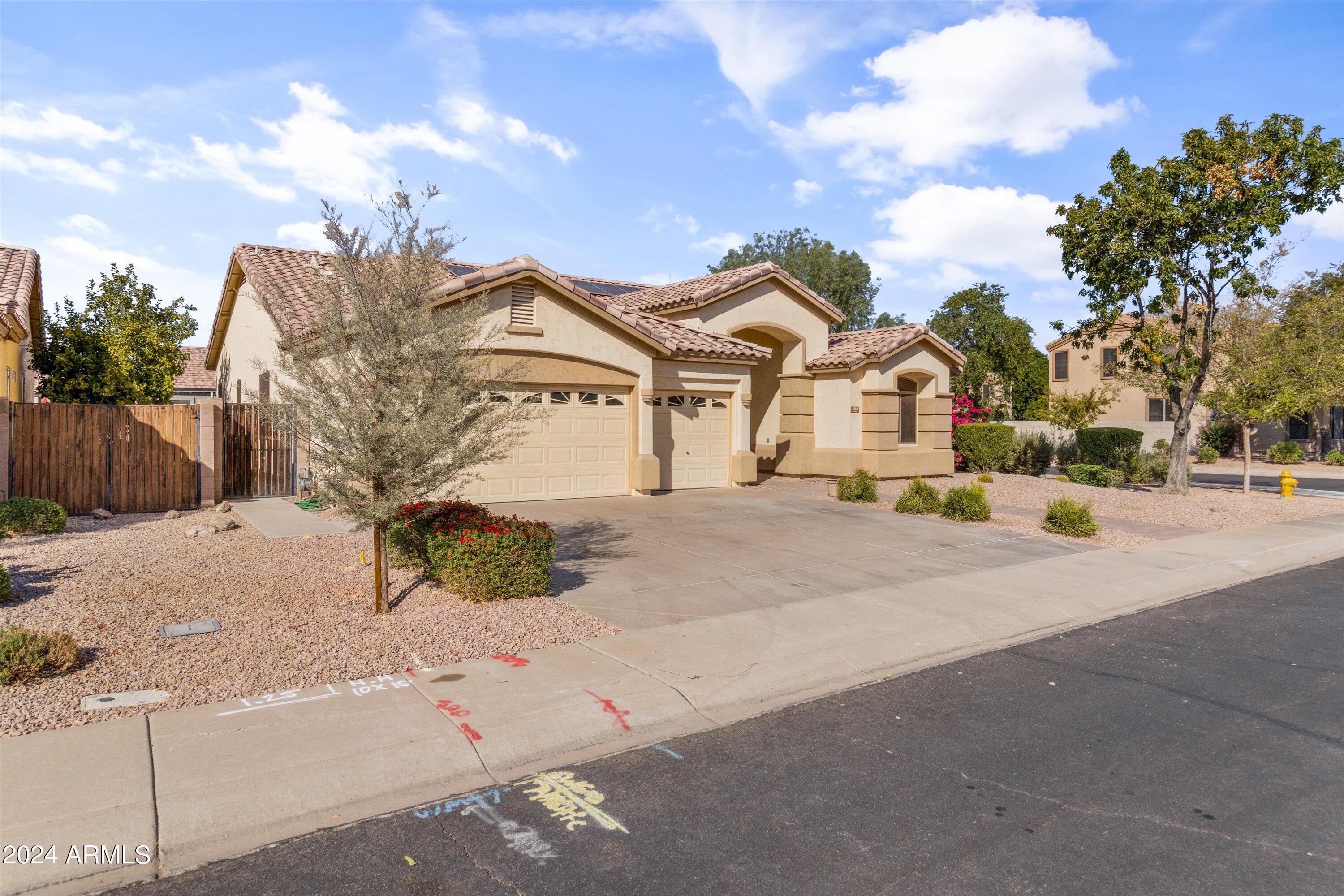 2860 East Nunneley Road Gilbert, AZ 85296 - Photo 3 of 28 a front view of a house with a yard and garage