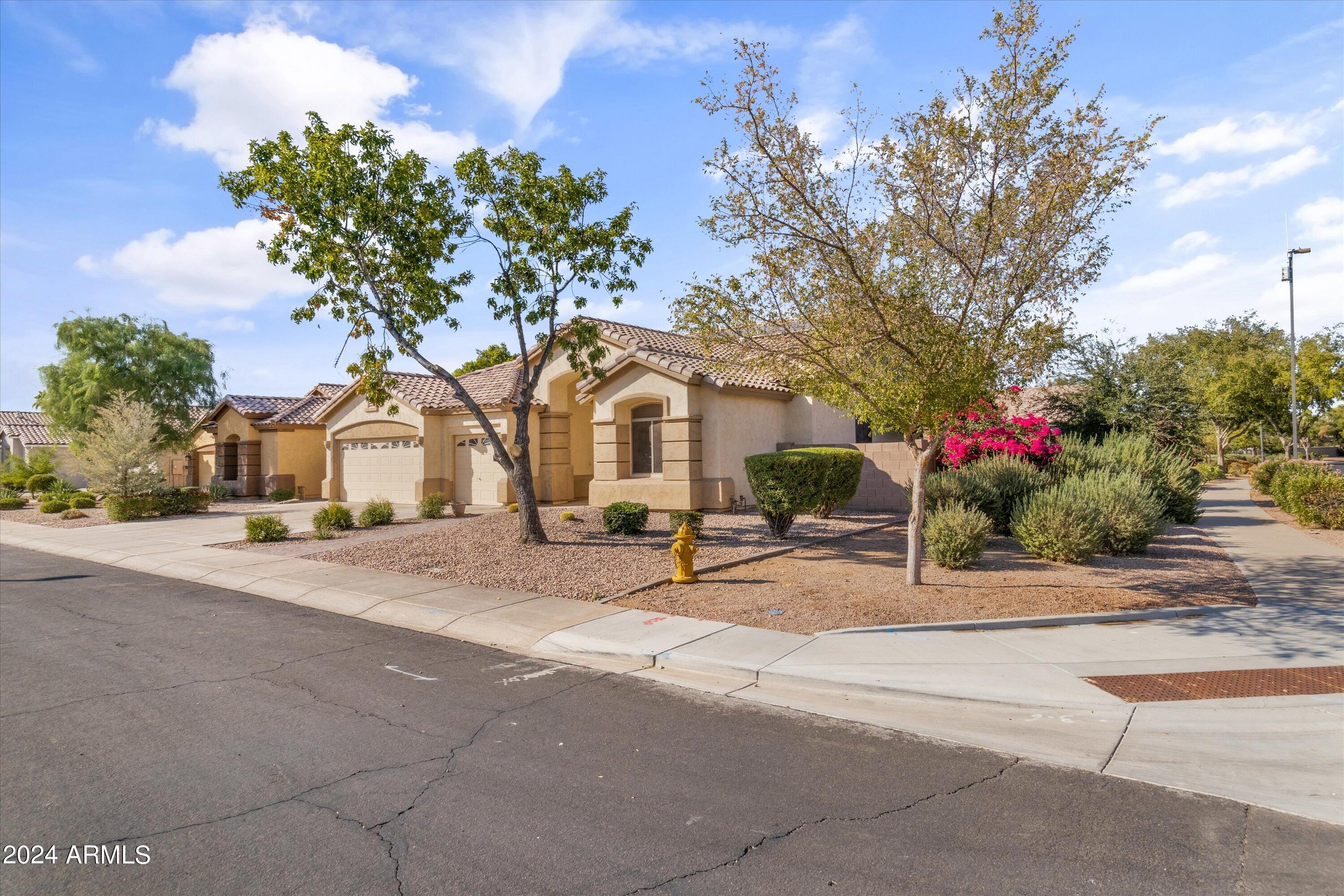 2860 East Nunneley Road Gilbert, AZ 85296 - Photo 4 of 28 a white building with a bench in front of it