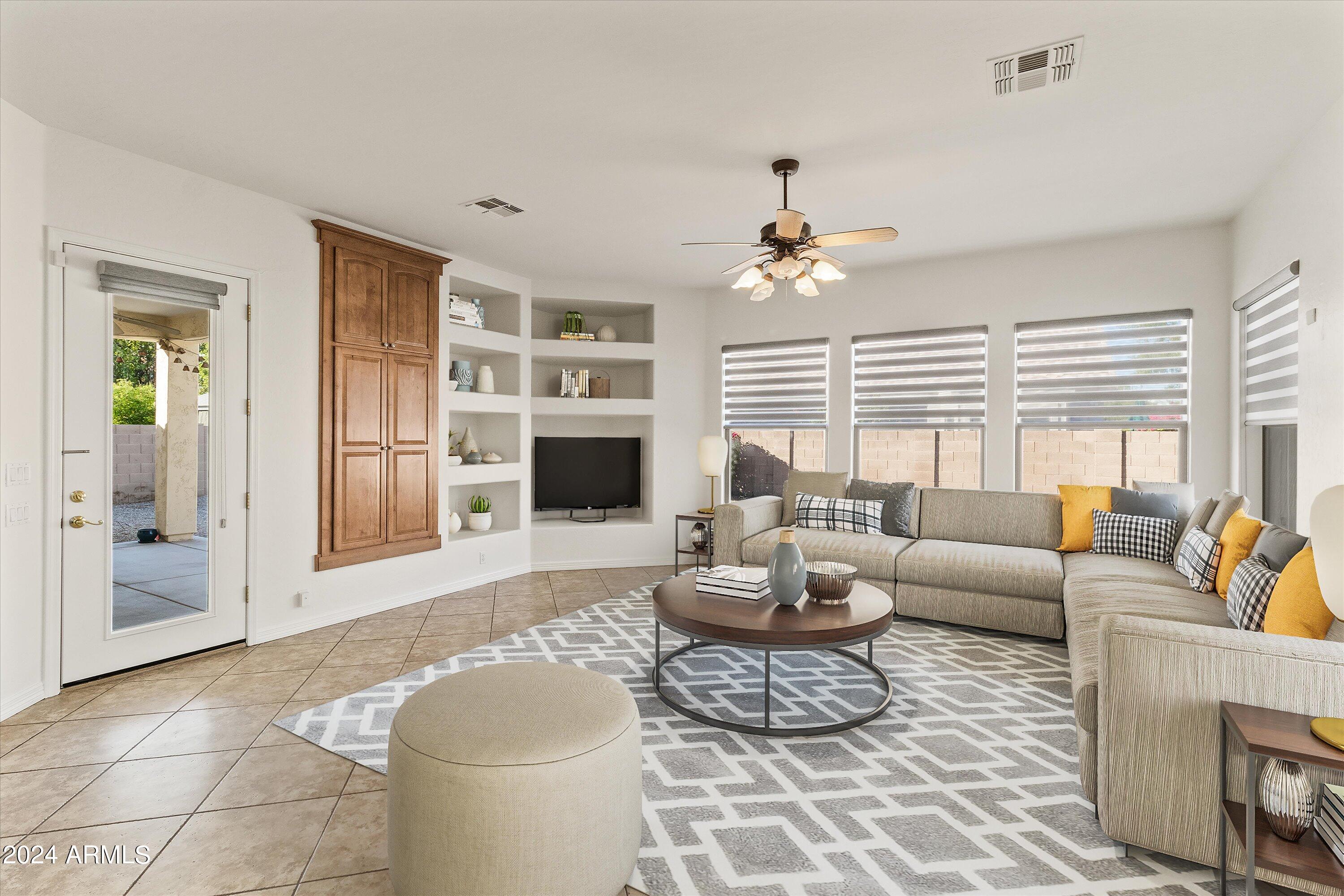 2860 East Nunneley Road Gilbert, AZ 85296 - Photo 6 of 28 a living room with furniture a fireplace and a flat screen tv