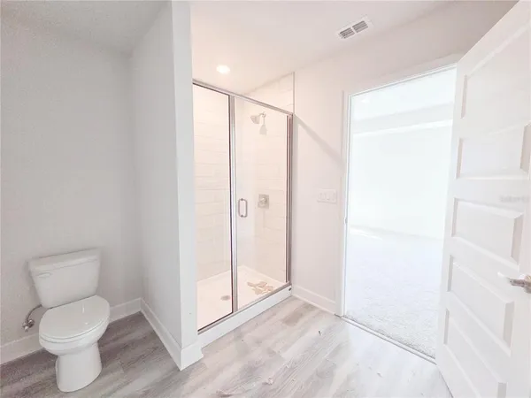 a view of a closet with racks on the wall
