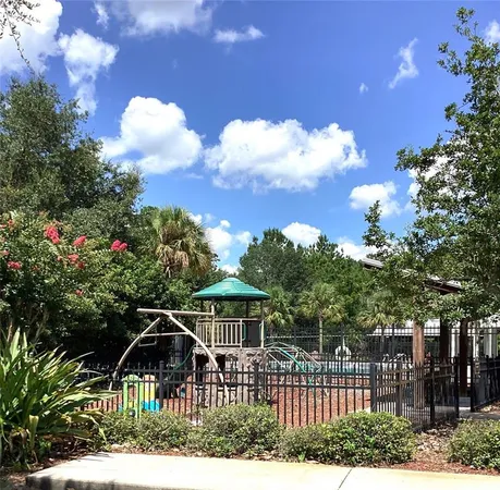 a view of a lake with a yard and large trees