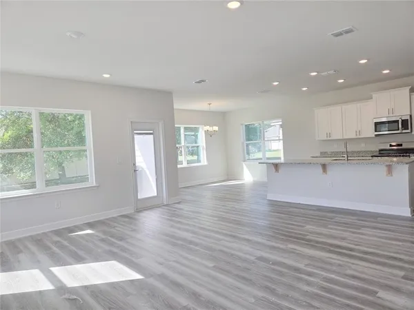 a view of kitchen with wooden floor and window