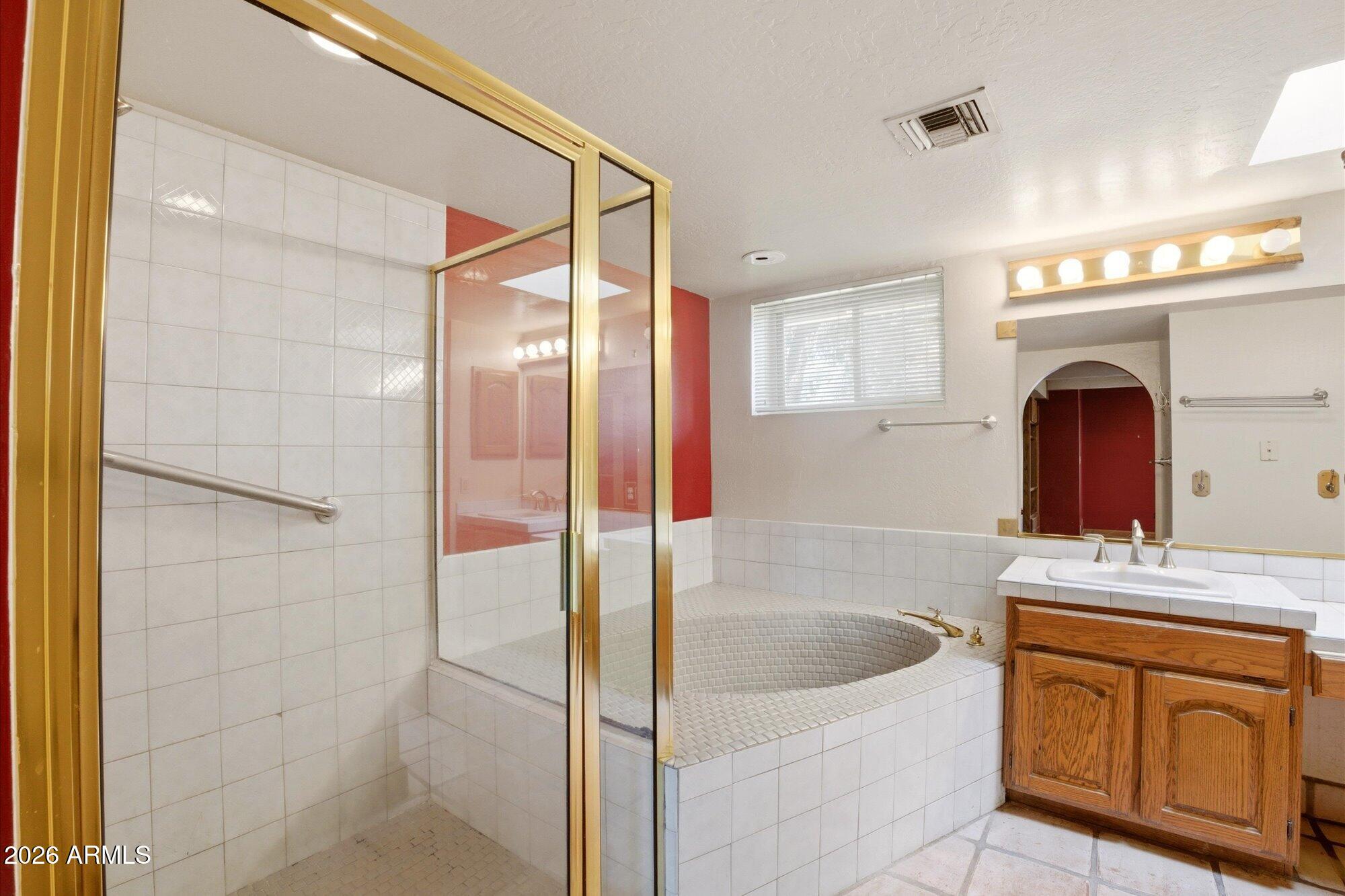 8324 North 8th Avenue Phoenix, AZ 85021 - Photo 13 of 39 a bathroom with a granite countertop sink a mirror a bathtub and shower