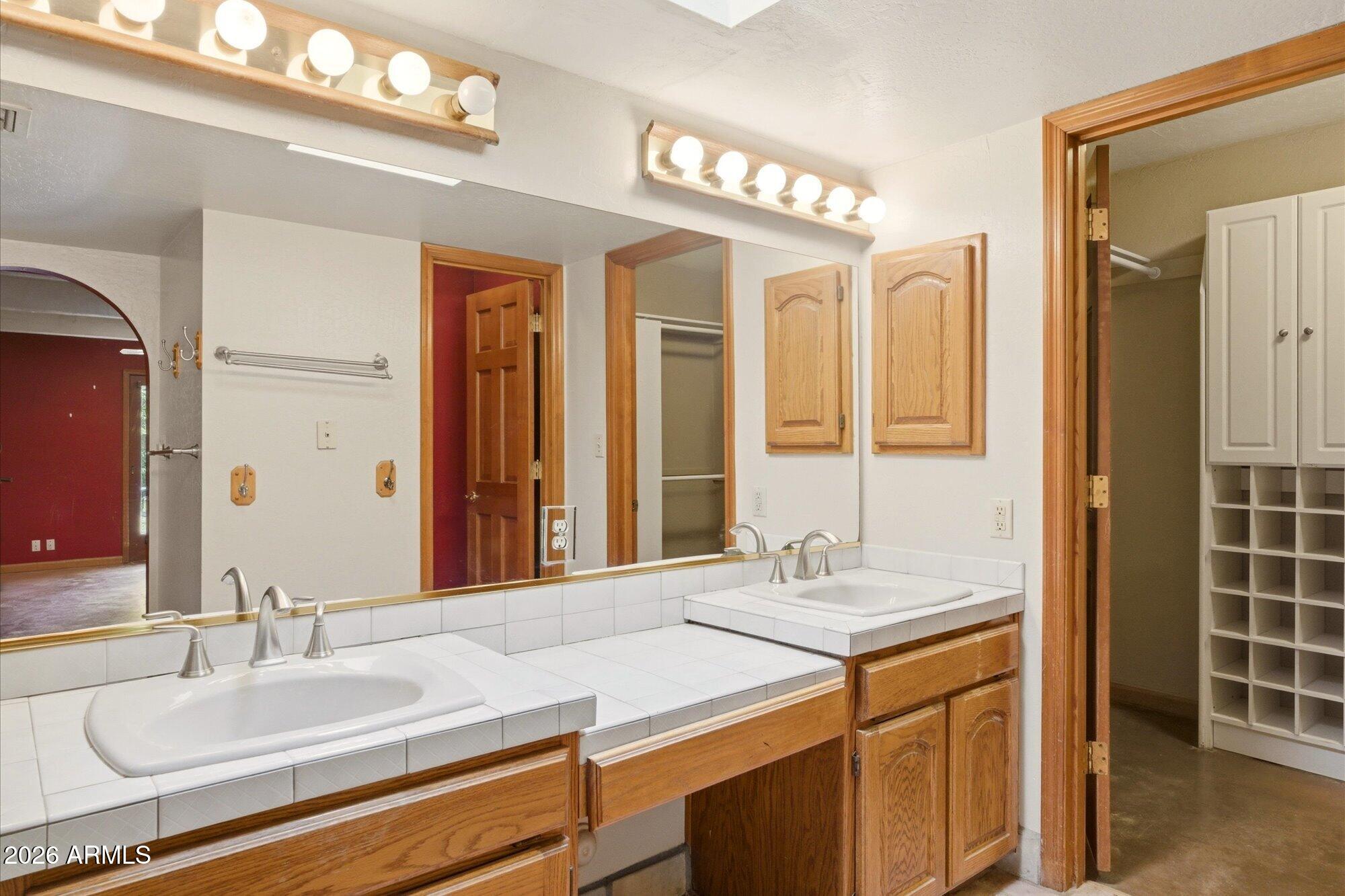 8324 North 8th Avenue Phoenix, AZ 85021 - Photo 14 of 39 a bathroom with a granite countertop sink a mirror and a shower