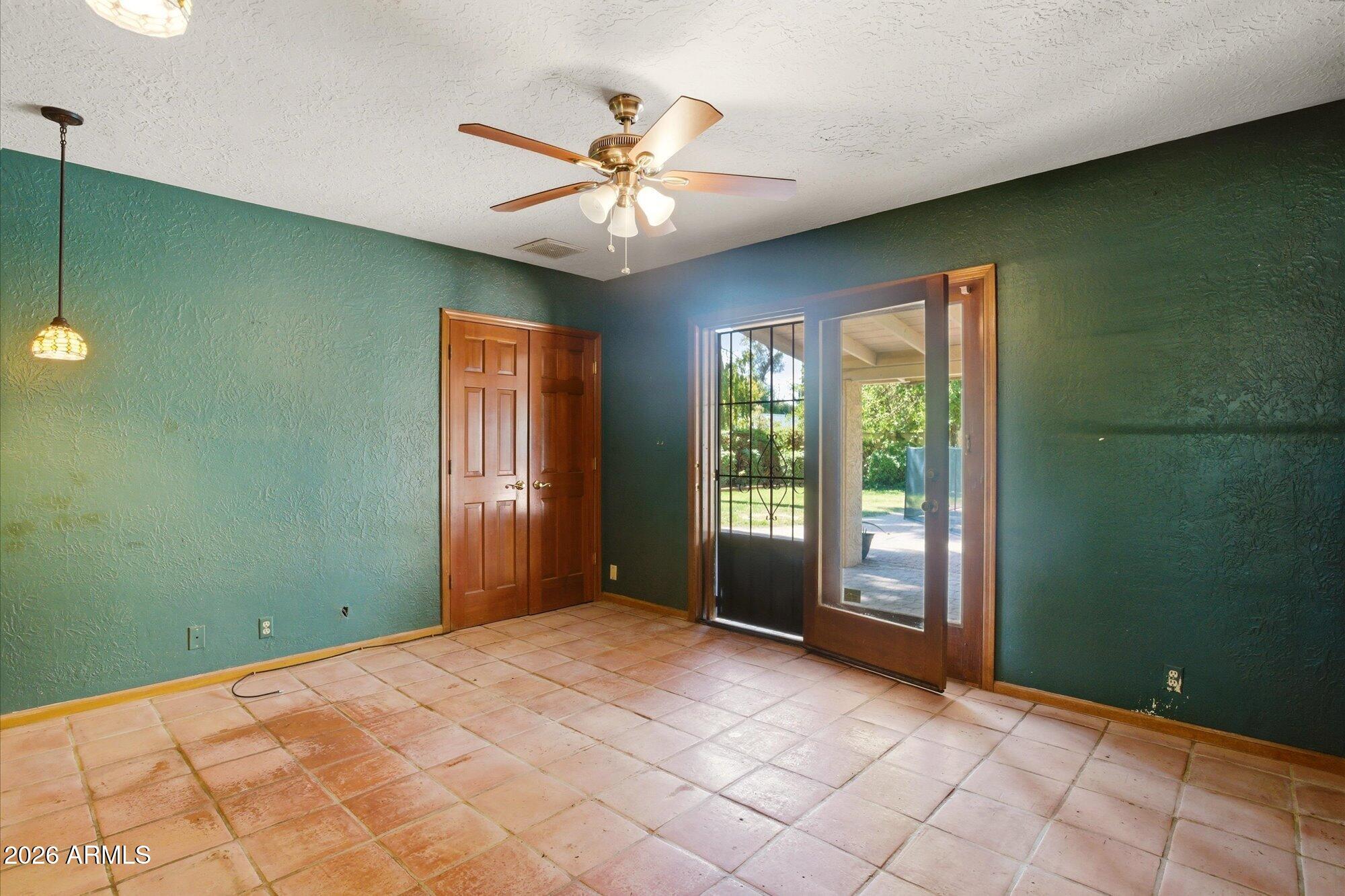 8324 North 8th Avenue Phoenix, AZ 85021 - Photo 17 of 39 a view of an empty room with window and chandelier fan