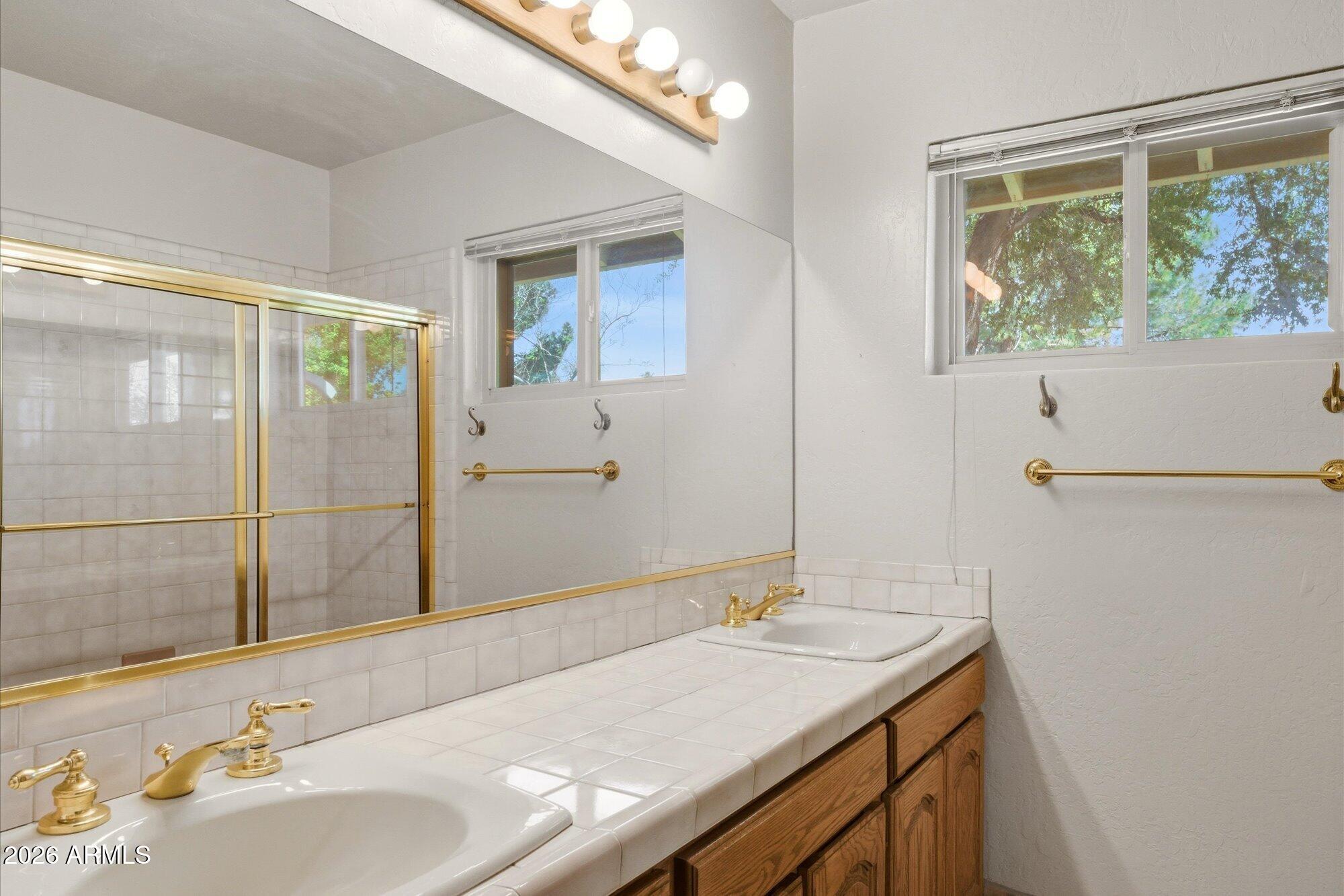 8324 North 8th Avenue Phoenix, AZ 85021 - Photo 18 of 39 a bathroom with a granite countertop sink and a mirror