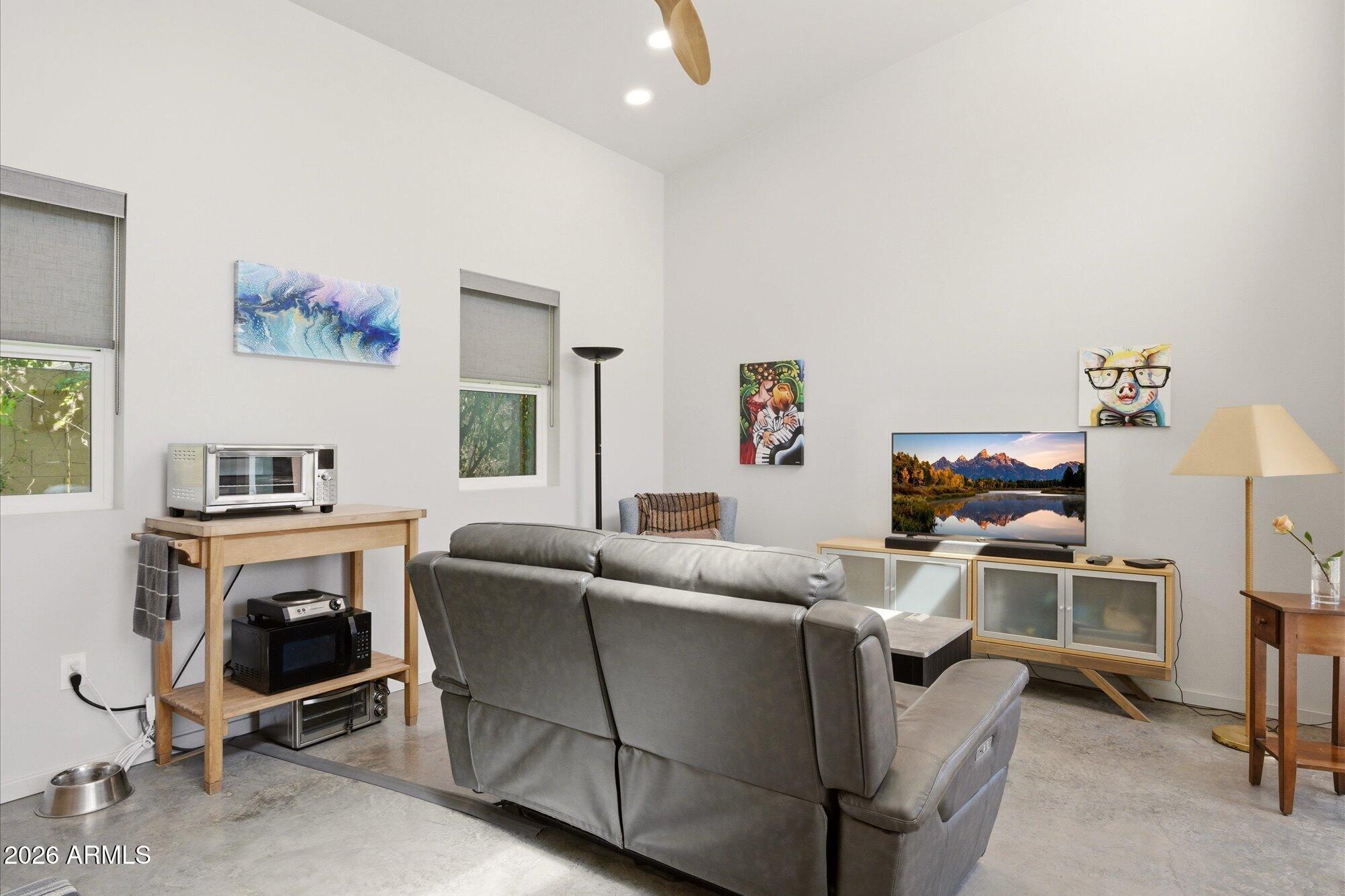 8324 North 8th Avenue Phoenix, AZ 85021 - Photo 21 of 39 a living room with furniture a flat screen tv and a fireplace