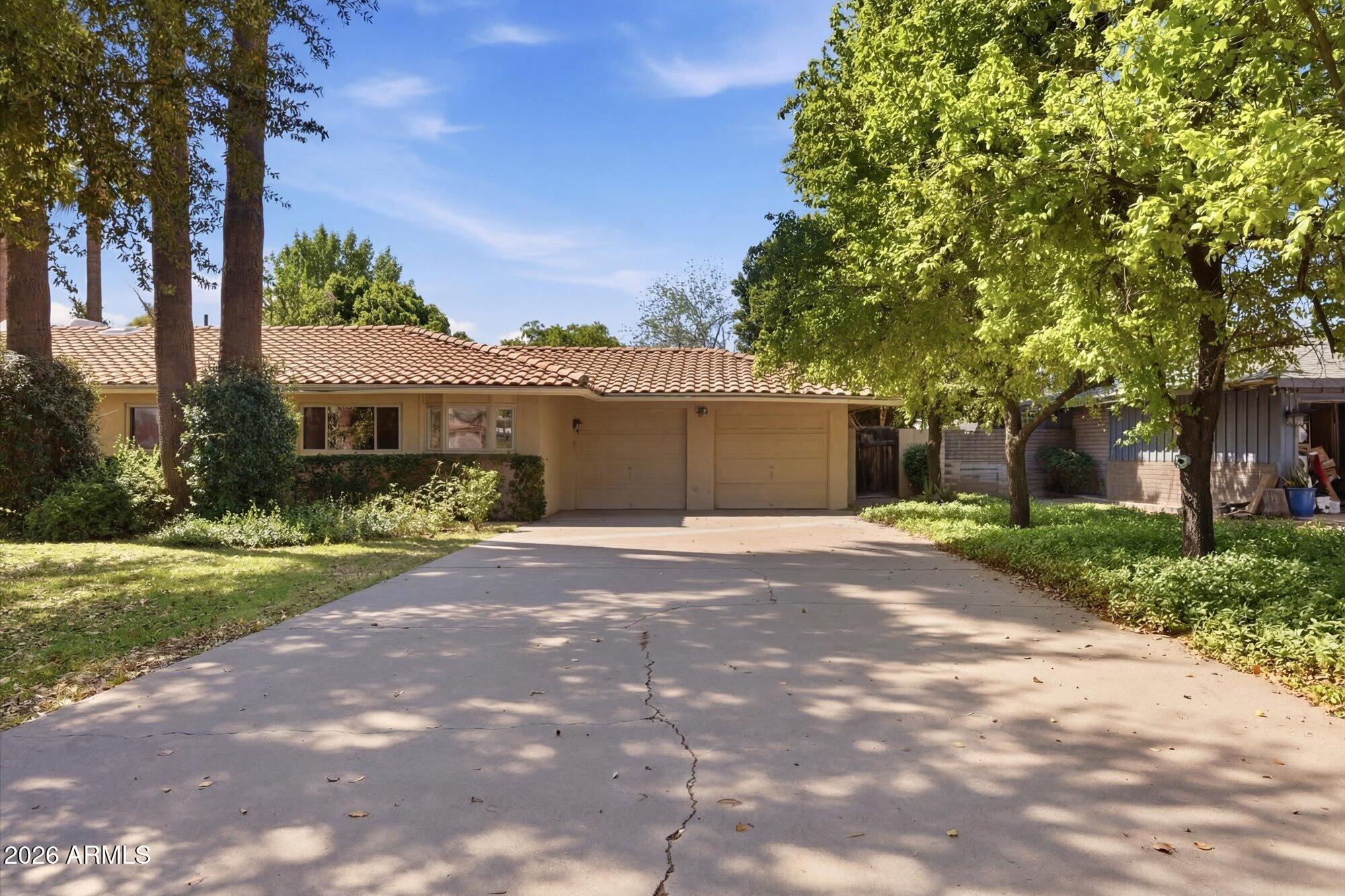 8324 North 8th Avenue Phoenix, AZ 85021 - Photo 3 of 39 a front view of a house with a garden and trees