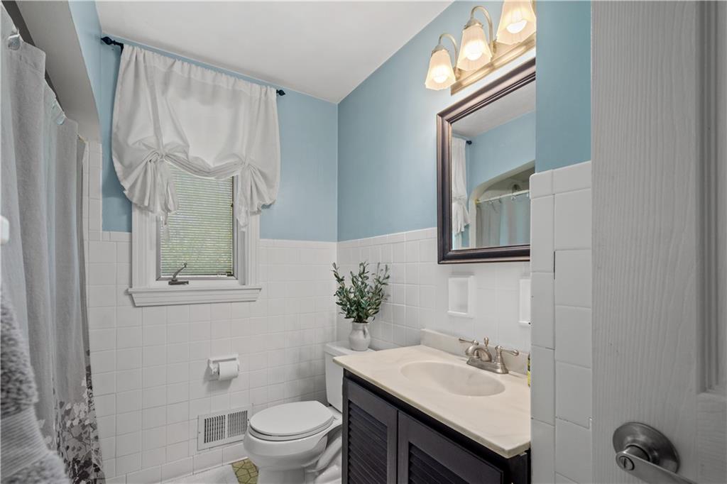 1376 Morrow Road Pittsburgh, PA 15241 - Photo 14 of 25 a bathroom with a sink vanity granite toilet and a mirror