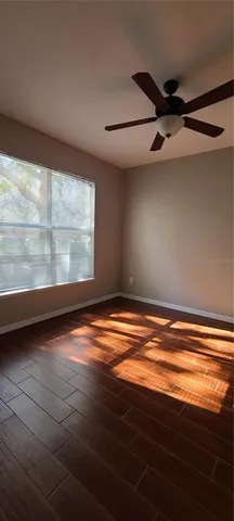 a bedroom with a bed and a ceiling fan