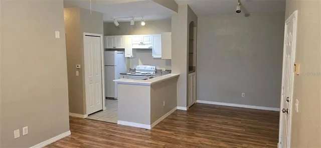 a view of a kitchen with wooden floor