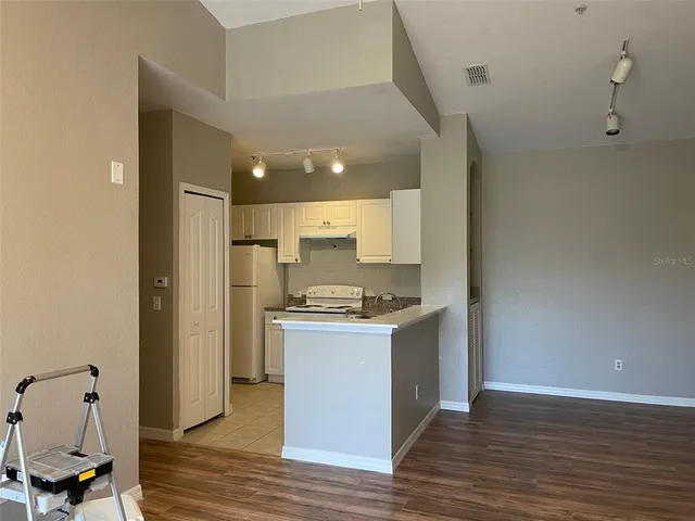 a kitchen with kitchen island a stove and a refrigerator