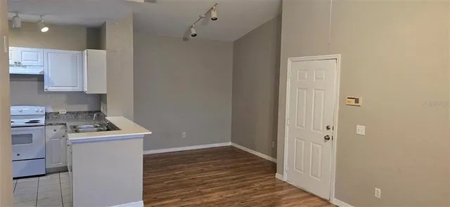 a room with a stove and a refrigerator