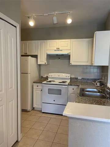 a kitchen with stainless steel appliances granite countertop a sink and a stove