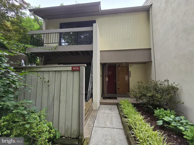 a front view of house and yard with green space
