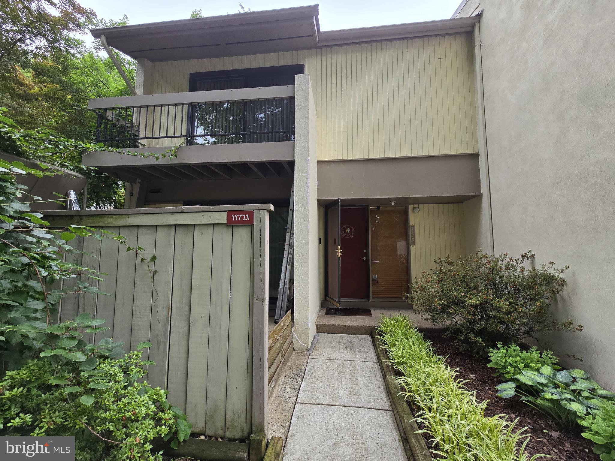 a front view of house and yard with green space