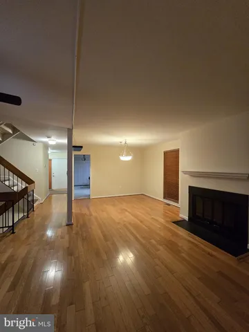 an empty room with closet and fan